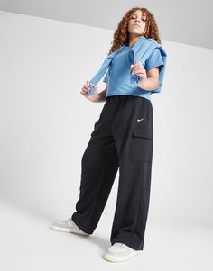 Keep your street style laidback with these junior girls' Wide Leg Cargo Joggers from Nike. In a Black colourway, these off-duty pants are made from a brushed cotton-poly fleece, with Dri-FIT tech added in to wick sweat away. They have a drawcord tie on the elasticated waistband to cinch in the top hem, while the wide legs offer room at the ankles. Finished off with spacious cargo pockets and the signature Swoosh. Machine washable. Nike Cargo Pants, Nikes Girl, Cargo Joggers, Nike Tech, Nike Blazer, Junior Outfits, Jd Sports, Wide Legs, Kids Nike