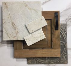 marble and wood are on display at the art gallery, including two square pieces of artwork