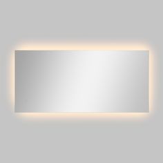 a bathroom mirror that is lit up and reflecting the light on it's side