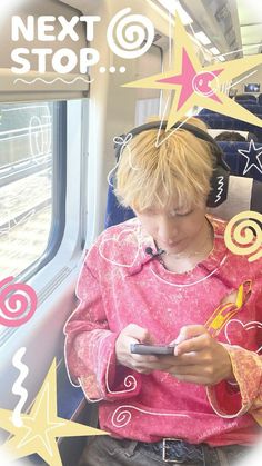 a person sitting on a train with headphones and looking at a cell phone in their hand