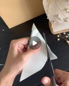 someone is cutting paper with scissors on a table