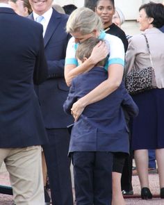 a man and woman hug each other while others look on