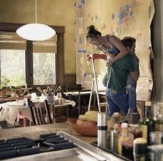 two people are standing in a kitchen area