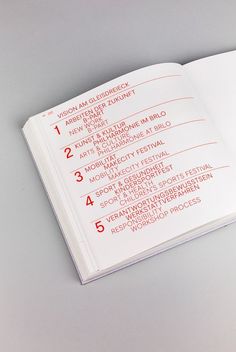 an open book with red numbers on the cover and page numbers in each section,