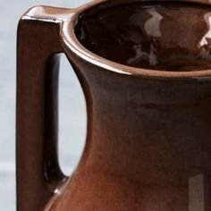 a brown vase sitting on top of a table