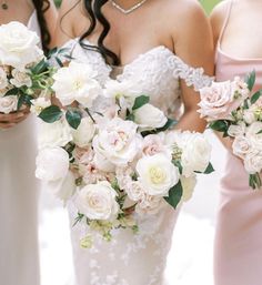 three bridesmaids holding bouquets of white and pink flowers in their hands at the same time