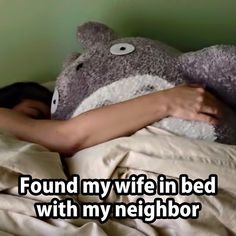 a person laying in bed with a teddy bear