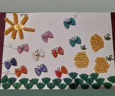 an art project made out of paper with different colored butterflies and flowers on the side