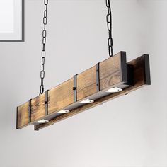 a wooden light fixture with four lights hanging from it's sides and two chains on each side