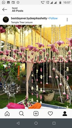 the table is covered with pink and white flowers, beads, and other things hanging from it