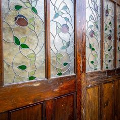 two wooden doors with stained glass panels on them