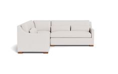 a white sectional couch sitting on top of a white floor