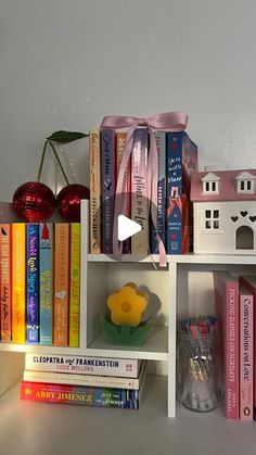 a shelf filled with books and toys on top of it