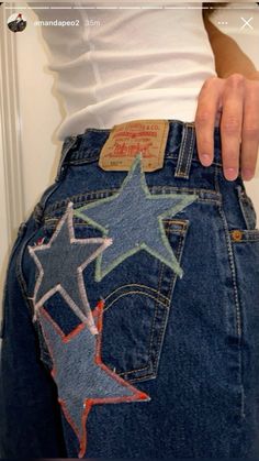 someone is showing off their jeans with stars painted on the bottom and back pockets