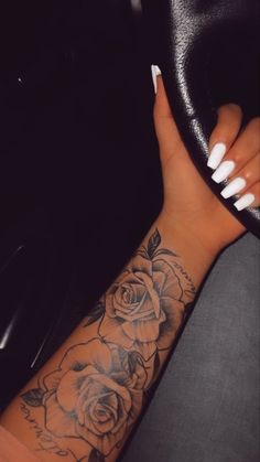 a woman's arm with a rose tattoo on it