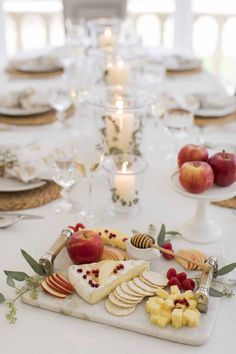 the table is set with apples, cheese and crackers for an appetizer