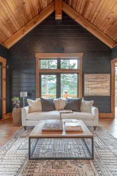 a living room filled with furniture next to a large wooden ceiling mounted flat screen tv