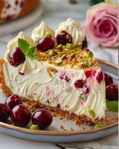 there is a piece of cake on the plate with cherries and pistachios