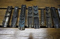 several different types of knives are lined up on a table