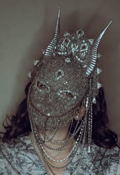 WAS £310, now £110! This fantastical mask is made from grey chenille and chiffon and is intricately beaded with silver seed beads and crystals. Chains hang down from either side and silver resin horns protude from the sides of the forehead. Small spiked elements are included here and there to give more of an edge. Not a fainthearted piece and completely unique! The 'Erembour' mask won't be recreated. Bone Headpiece, Horned Mask, Chain Headdress, Silver Headpiece, Beaded Mask, Silver Mask, Silver Head Piece, Crystal Chain, Dressed To The Nines