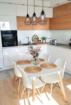 the table is set for four with white chairs