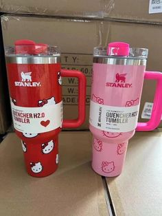 two hello kitty travel mugs are on display