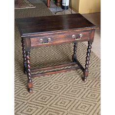 an old wooden table sitting on top of a carpeted floor