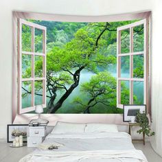 an open window with a view of a tree and river outside it in the bedroom