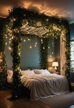 a bed covered in greenery with lights hanging from it's headboard and pillows