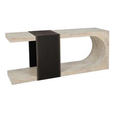 a white and black sculpture sitting on top of a wooden shelf