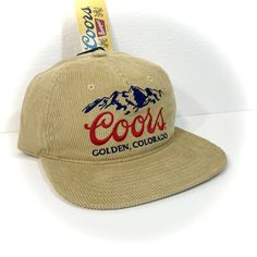 DETAILS: - Great-looking COORS BEER HAT for adults  - Tan with embroidered accents  - Officially licensed  - Unstructured crown with flat bill, retro 90s style   (new hat designed to look vintage) - Adjustable snapback - standard one size fits most adult  CONDITION: NEW WITH TAG   inventory ID#802401070TC2 Retro Snapback Hat With Embroidered Logo And Curved Brim, Retro Snapback Hat With Embroidered Logo, Retro Hat With Embroidered Logo For Baseball Season, Retro Dad Hat With Embroidered Logo Snapback, Throwback Adjustable Hat With Curved Brim, Retro Baseball Season Hat With Embroidered Logo, Retro Dad Hat With Embroidered Logo, Retro Adjustable Snapback Hat For Sports, Adjustable Curved Brim Throwback Hat