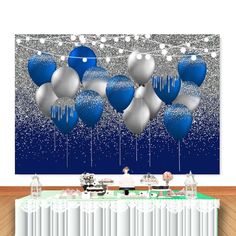 blue and silver balloons floating in the air on a string over a table with white curtains