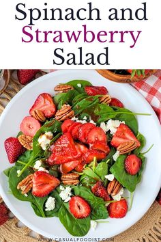 spinach and strawberry salad on a white plate