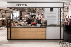 an open kitchen with two chefs preparing food