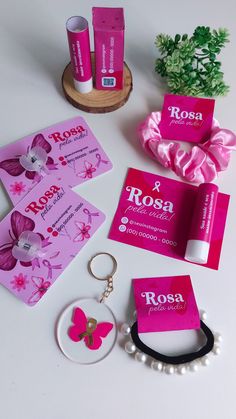 pink business cards, keychain, and other items laid out on a table