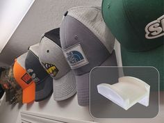 several hats are lined up on a shelf