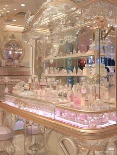 the inside of a perfume store with many bottles and stools