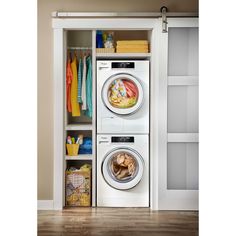 a washer and dryer sitting in front of an open closet