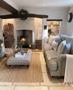 a living room filled with furniture and a fire place in the middle of it's wall