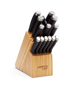 a set of knives sitting on top of a wooden block in front of a white background