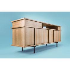 the sideboard is made out of wood and has metal legs on both sides,