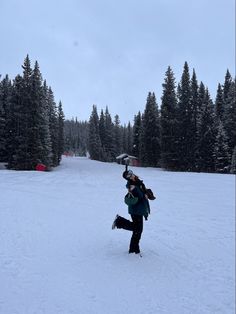 a person on skis in the snow near trees