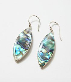 Embrace the allure of the ocean with these authentic Abalone earrings that are a beautiful representation of nature's artistry and a timeless accessory that complements your unique style. The natural iridescence of the abalone shell creates a stunning play of colors, ranging from iridescent blues to hints of greens, ensuring that these earrings are as unique as the wearer. Material: Sterling Silver with Abalone Shell Dimensions: 2"L Weight: .32 oz. Imported Abalone Earrings, Timeless Accessories, Shell Earrings, Abalone Shell, The Ocean, Unique Style, Shells, Sterling Silver, Silver