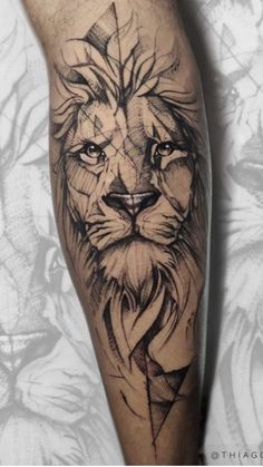 a man's leg with a lion tattoo on it and an arrow in the middle