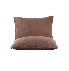 a brown pillow sitting on top of a white wall