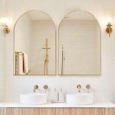 two white sinks sitting under mirrors in a bathroom next to a wall mounted faucet