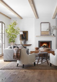 a living room filled with furniture and a fire place