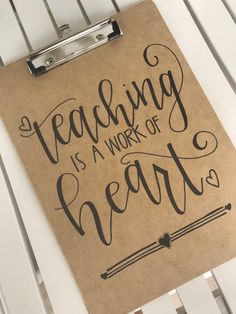 a clipboard with writing on it that says teaching is a work of heart so