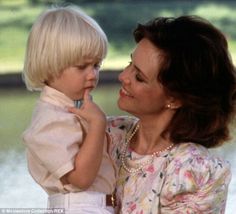 a woman holding a small child in her arms