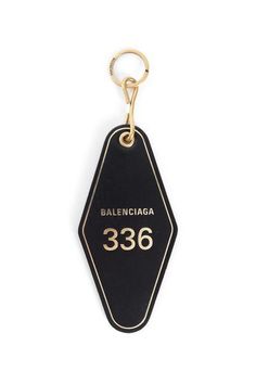 a black and gold keychain with the number 350 written on it's side